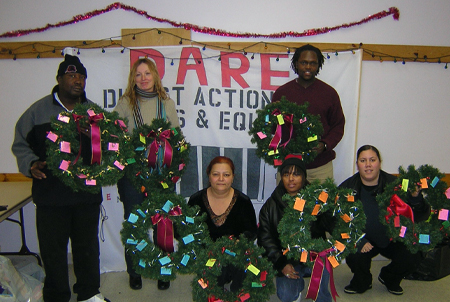 dare volunteers holding wreaths at christmas events